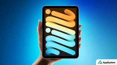 iPad mini tenu verticalement avec écran aux formes colorées