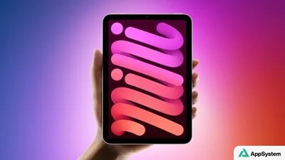 Une tablette compacte tenue en main affiche un fond d’écran coloré.