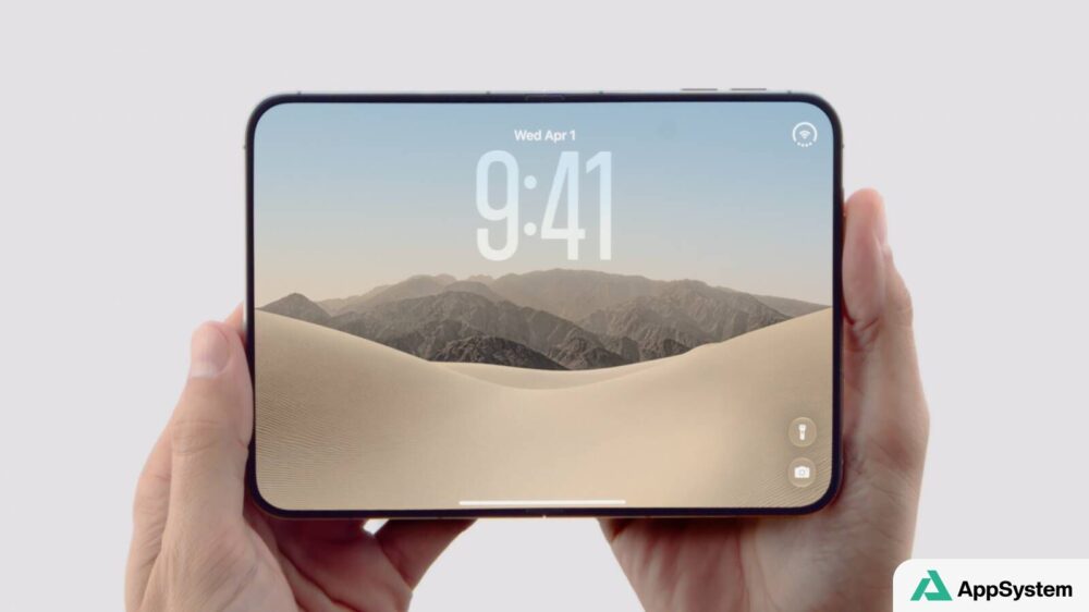 iPhone Duo tenu horizontalement, avec écran carré affichant un paysage désertique