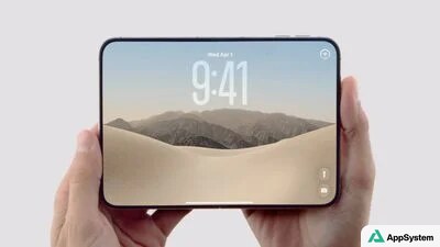 iPhone Duo pliable tenu en main, écran affichant des montagnes