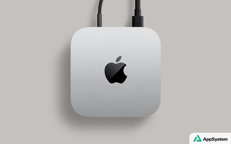 Mac mini Apple argenté vu de dessus avec câbles connectés