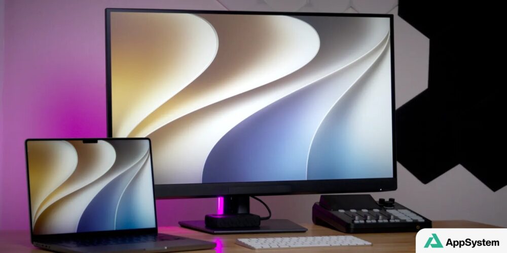 Ordinateur portable et écran affichant le fond d’écran de macOS